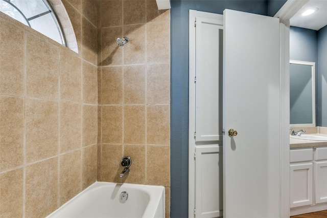 bathroom with vanity and tiled shower / bath combo