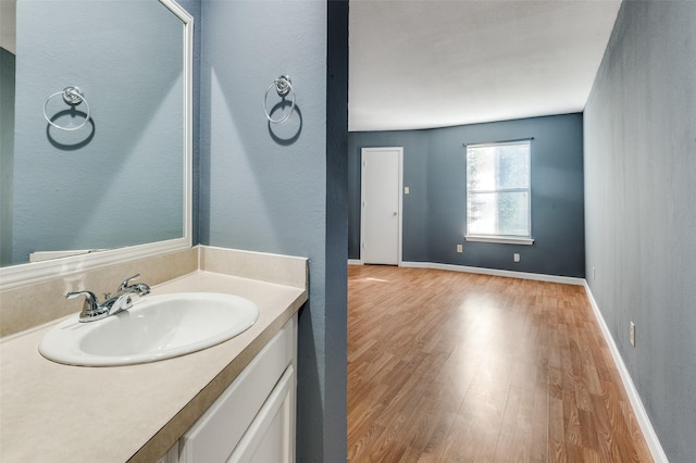 bathroom with hardwood / wood-style flooring and vanity