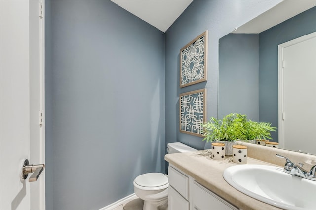 bathroom with vanity, toilet, and tile patterned floors