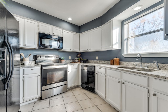 kitchen featuring black appliances, white cabinetry, sink, light stone counters, and light tile patterned flooring