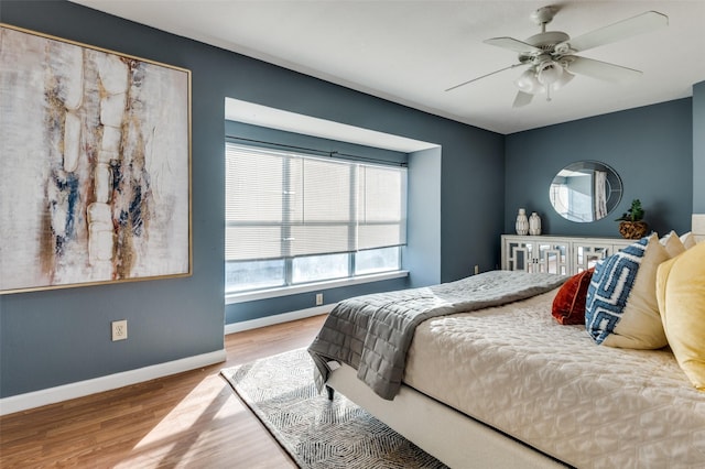 bedroom with ceiling fan and light hardwood / wood-style floors