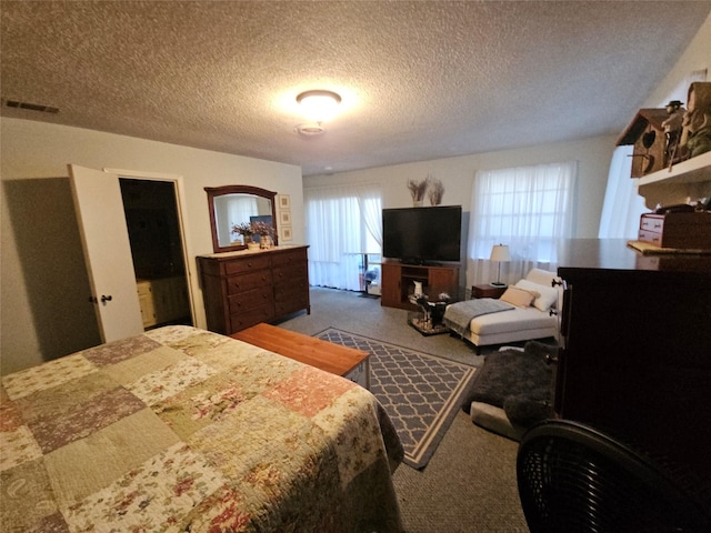 carpeted bedroom featuring a textured ceiling