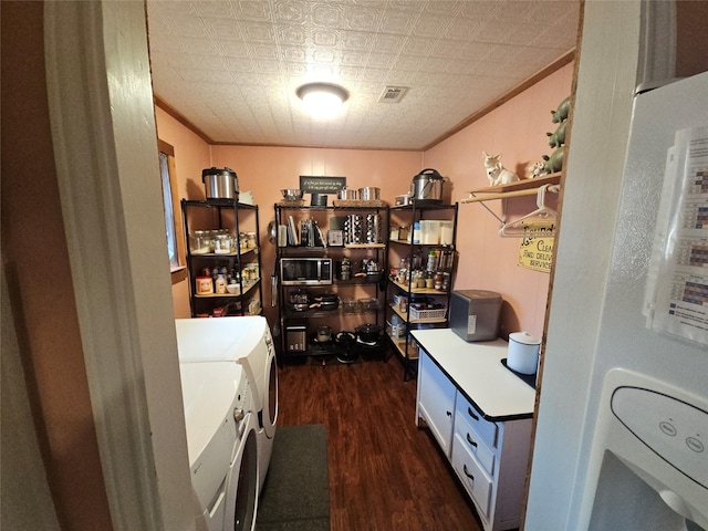 office area featuring dark wood-type flooring, washer / dryer, and ornamental molding