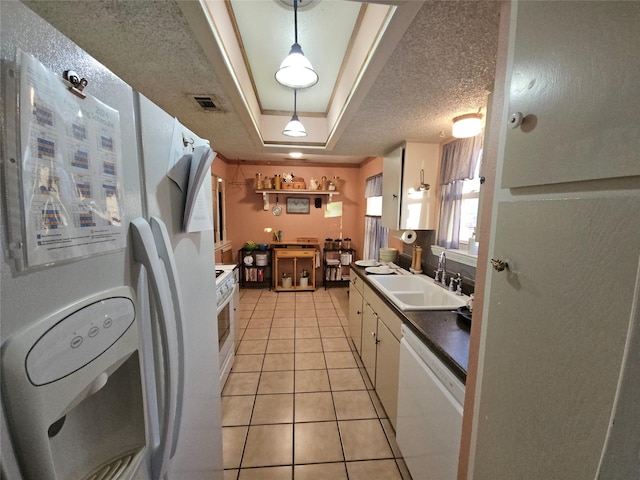 kitchen featuring white cabinets, white appliances, hanging light fixtures, and sink