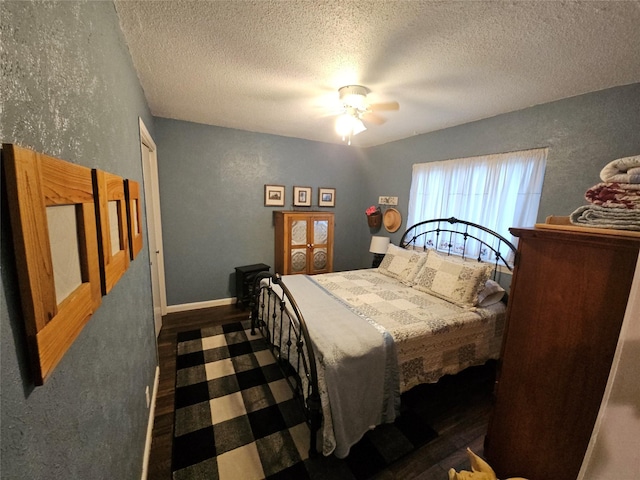 bedroom with ceiling fan and a textured ceiling