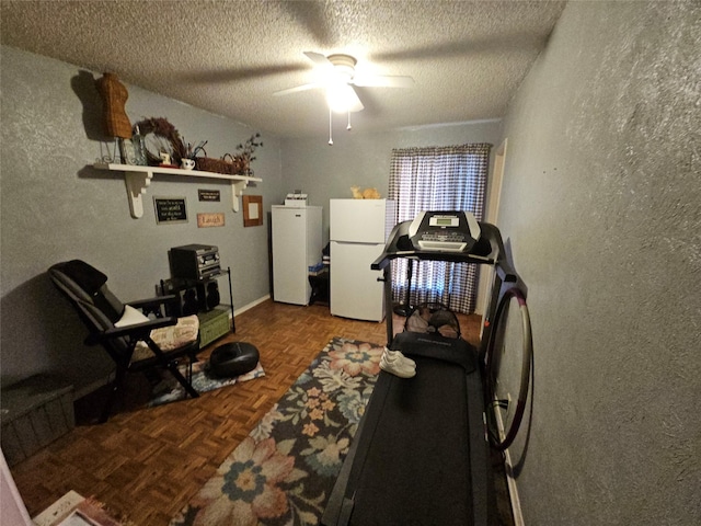 exercise area with ceiling fan, parquet floors, and a textured ceiling