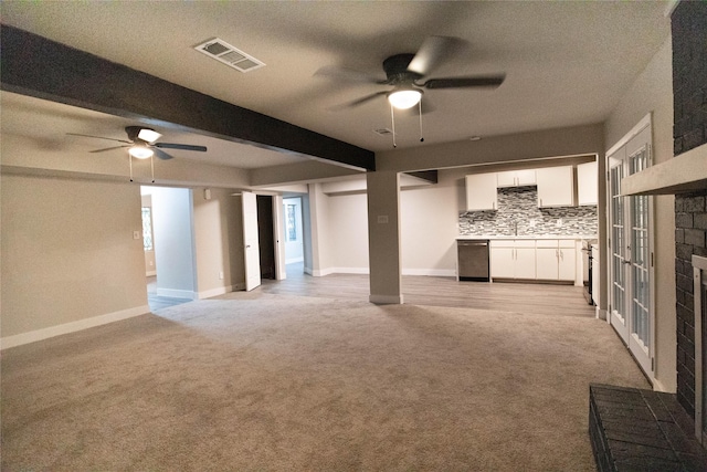 unfurnished living room featuring ceiling fan, light carpet, and beam ceiling