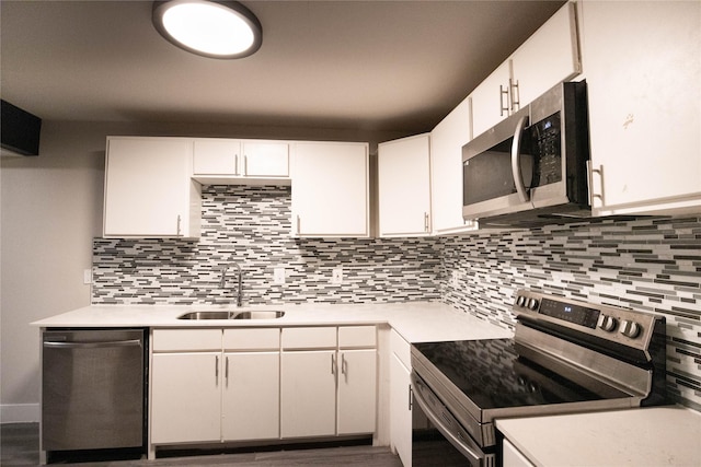 kitchen with sink, white cabinets, decorative backsplash, and appliances with stainless steel finishes