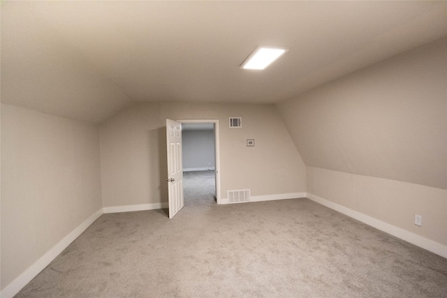 bonus room featuring vaulted ceiling and carpet flooring