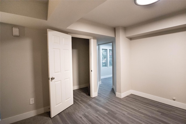 unfurnished bedroom with dark wood-type flooring