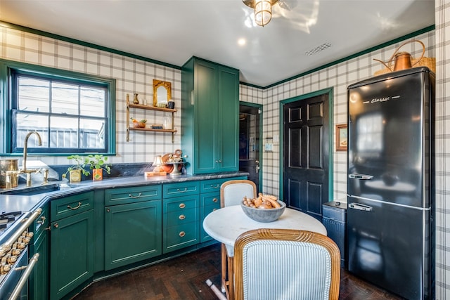 kitchen featuring crown molding, green cabinetry, sink, dark hardwood / wood-style floors, and stainless steel range