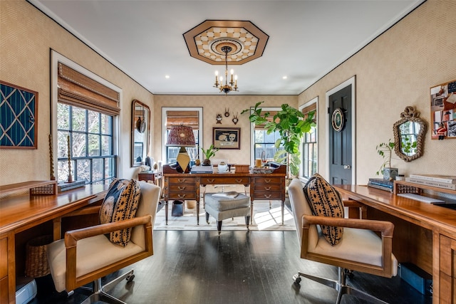 office area with hardwood / wood-style flooring, crown molding, and an inviting chandelier