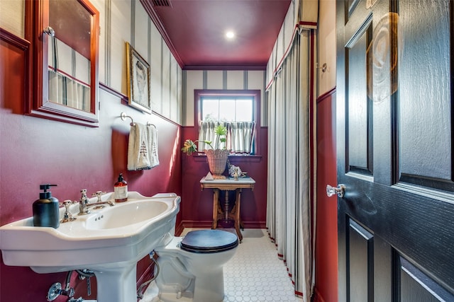 bathroom featuring toilet and crown molding