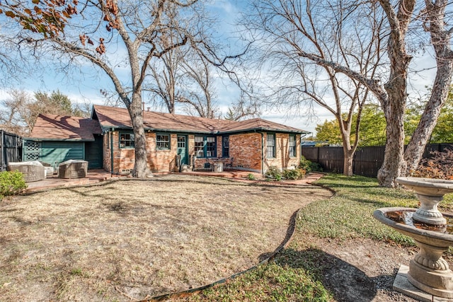 back of property featuring a lawn