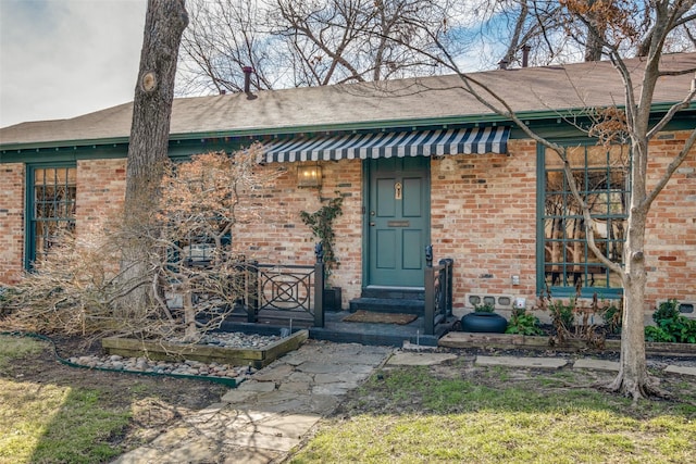 doorway to property featuring a yard