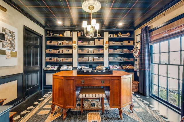 home office featuring built in shelves, crown molding, and an inviting chandelier