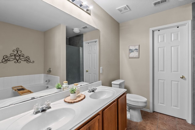 full bathroom featuring tile patterned flooring, vanity, shower with separate bathtub, and toilet