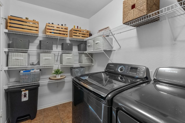 washroom featuring washing machine and dryer and tile patterned floors