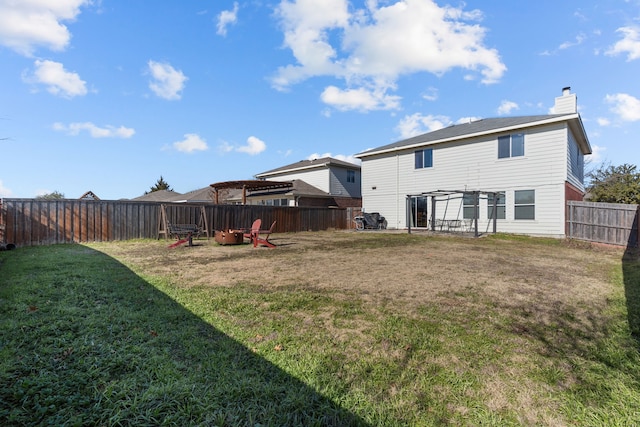 back of property featuring a pergola and a lawn