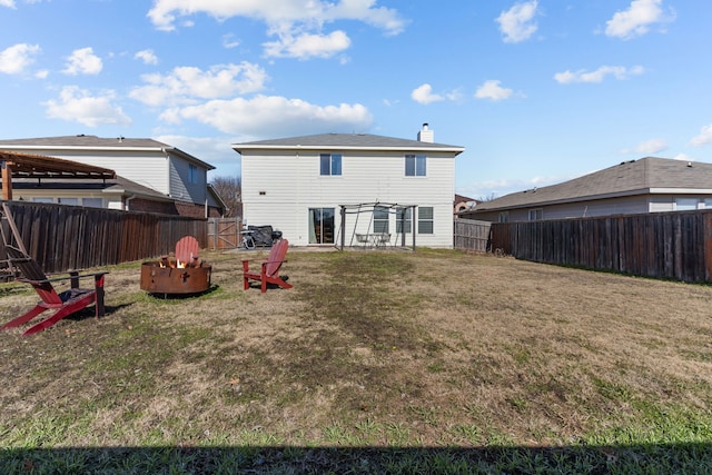 back of house with a lawn