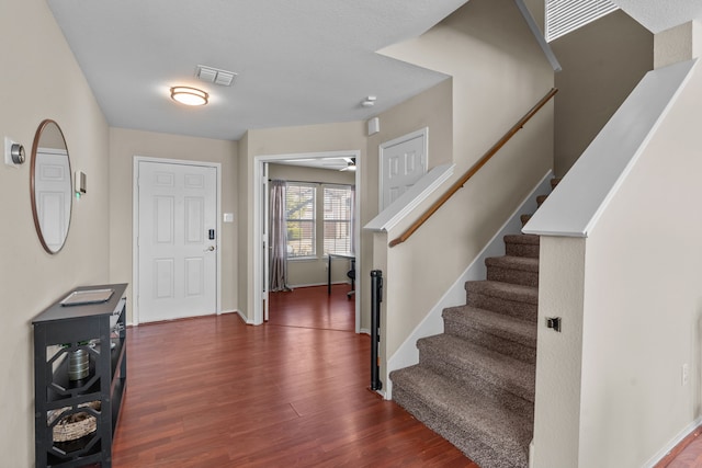 foyer entrance with dark wood-type flooring