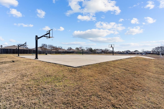 view of sport court with a yard