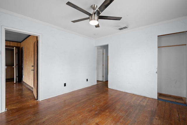 unfurnished bedroom with ornamental molding, dark hardwood / wood-style floors, and ceiling fan