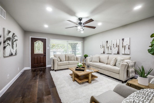 living room featuring ceiling fan and dark hardwood / wood-style floors