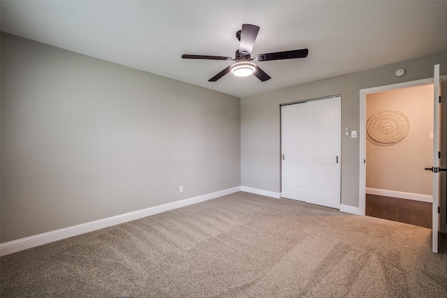 unfurnished bedroom with ceiling fan, carpet, and a closet