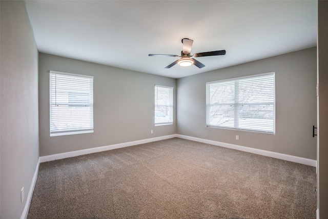 carpeted spare room featuring ceiling fan