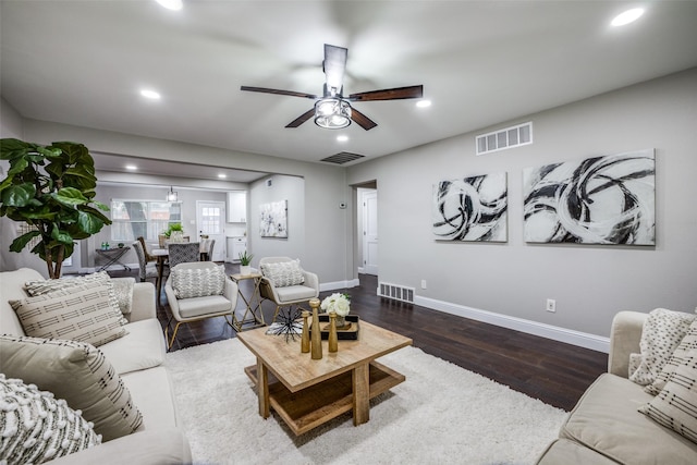 living room with ceiling fan and dark hardwood / wood-style floors