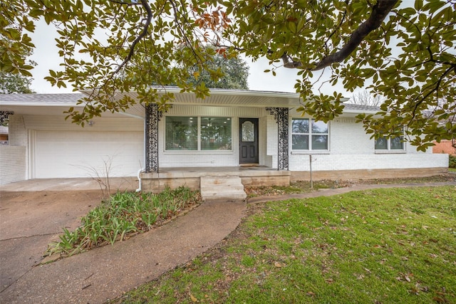 single story home featuring a garage and a front yard