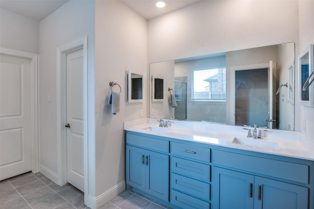 bathroom with tile patterned floors, a shower with door, and vanity