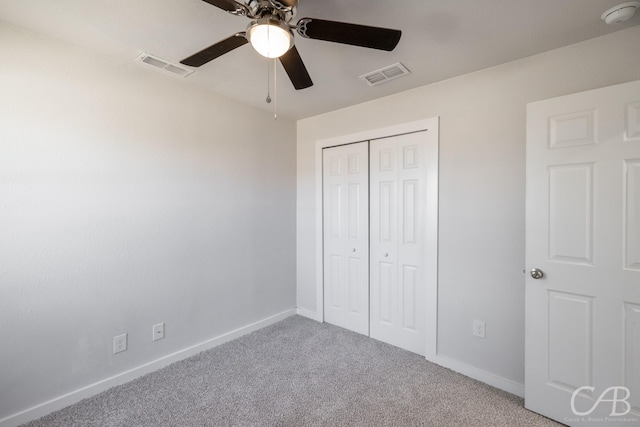 unfurnished bedroom with ceiling fan, carpet, and a closet