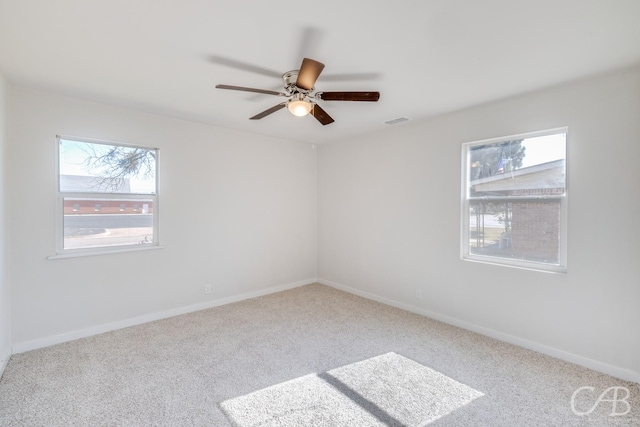 carpeted empty room featuring ceiling fan