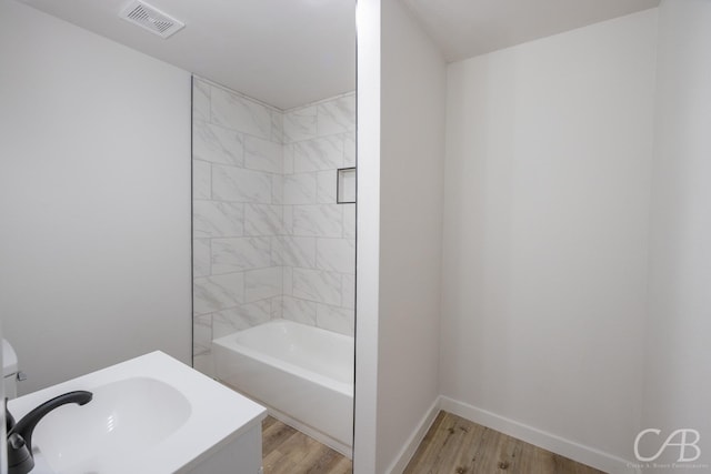 bathroom featuring wood-type flooring, toilet, and shower / bath combination