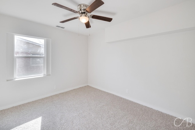 carpeted spare room with ceiling fan