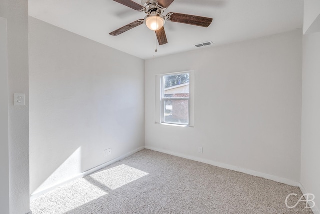 carpeted spare room with ceiling fan