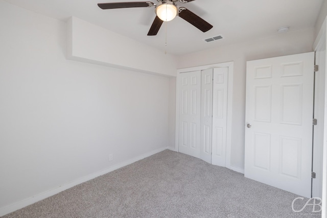 unfurnished bedroom featuring carpet floors, a closet, and ceiling fan