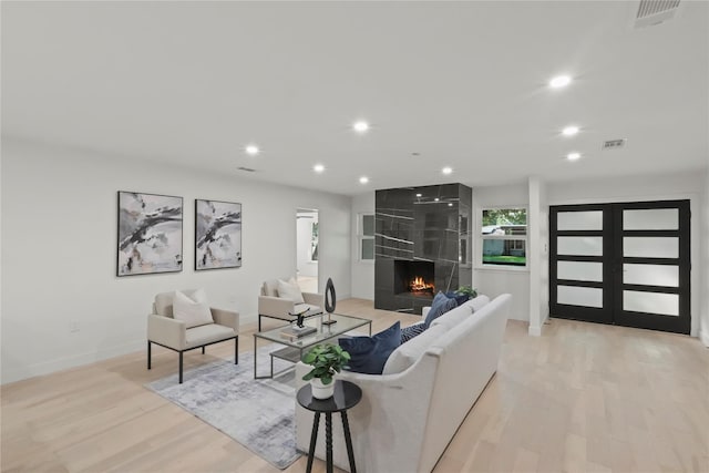 living room featuring light hardwood / wood-style floors and a fireplace