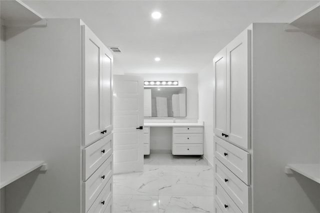 walk in closet featuring built in desk