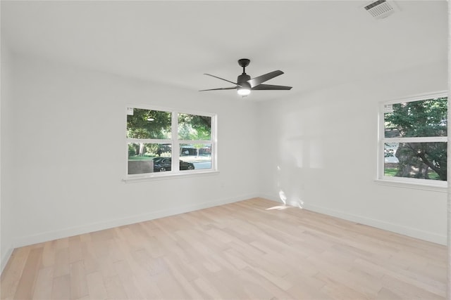 empty room featuring ceiling fan and light hardwood / wood-style flooring