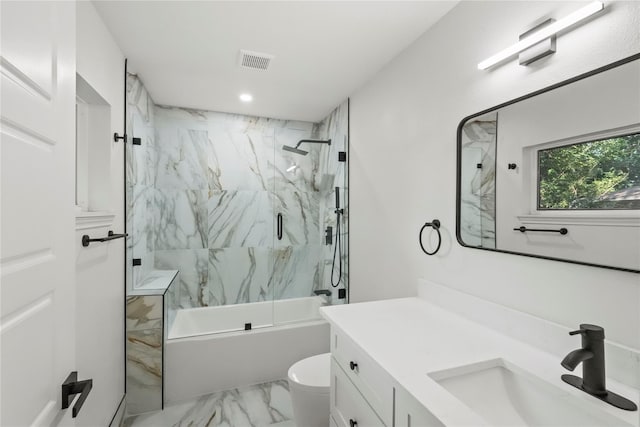 full bathroom with toilet, enclosed tub / shower combo, and vanity