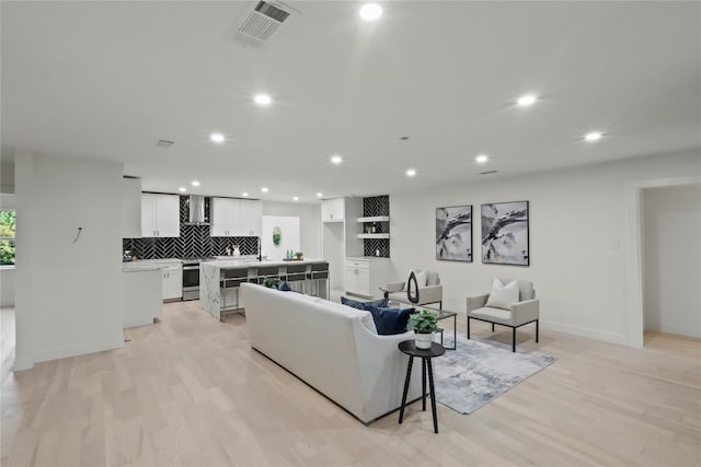 living room with light hardwood / wood-style flooring and a wealth of natural light