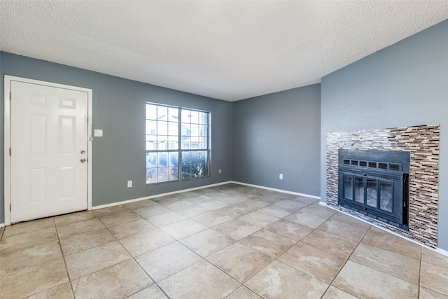 unfurnished living room with a fireplace, a textured ceiling, and light tile patterned floors