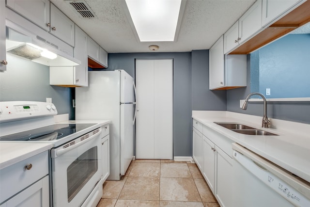 kitchen featuring sink, white cabinetry, white appliances, and a textured ceiling