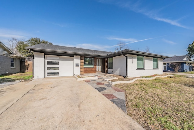 view of front of property with a garage and a front lawn