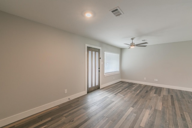 empty room featuring ceiling fan and dark hardwood / wood-style flooring