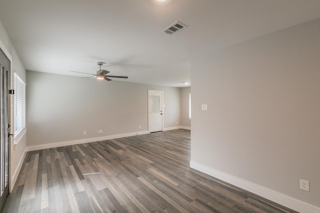 spare room with dark wood-type flooring and ceiling fan