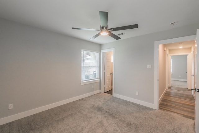 unfurnished bedroom featuring ceiling fan and light colored carpet